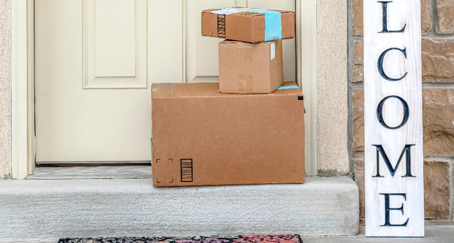 Packages on the doorstep of a home with a welcome sign in Evanston